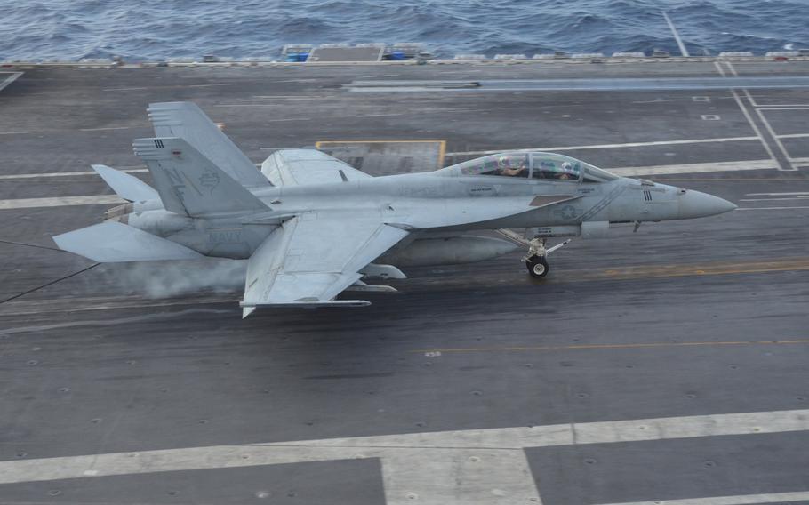 A U.S. Navy F/A-18 Super Hornet catches an arresting wire and lands on the USS Ronald Reagan, in international waters south of Atsugi, Japan, on Tuesday, Nov. 24, 2015. Japan said it had no current plans to join the U.S. on “freedom of navigation” exercises in the South China Sea, however it did not rule out future operations.