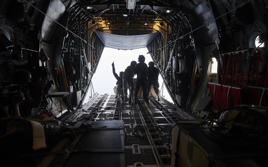 Airmen from the 374th Airlift Wing and Japan Air Self-Defense Force prepare to drop a box of humanitarian aid to villagers living on the atoll of Etol in Micronesia on Wednesday, Dec. 9, 2015.