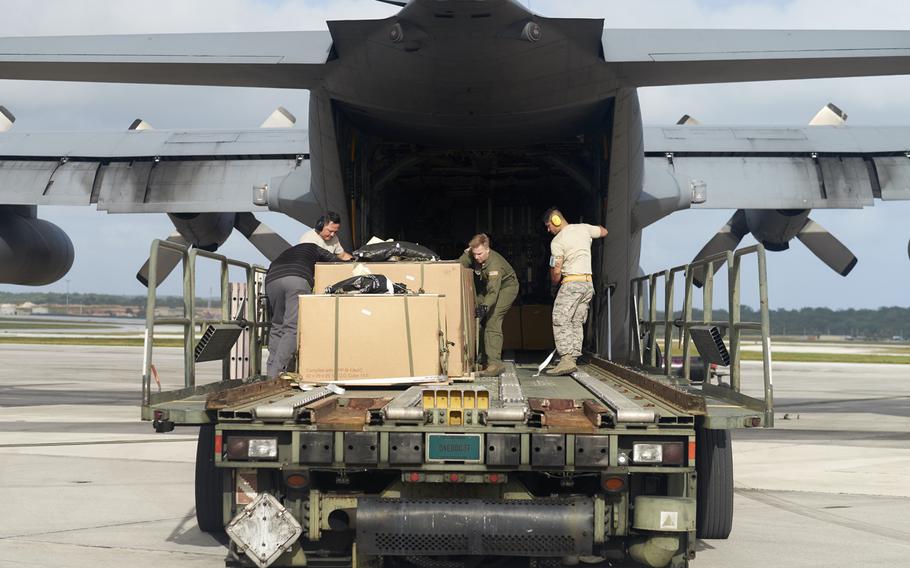 Airmen at Andersen Air Force Base in Guam load a C-130 Hercules from Yokota Air Base, Japan, in preparation for Operation Christmas Drop on Wednesday, Dec.9, 2015.