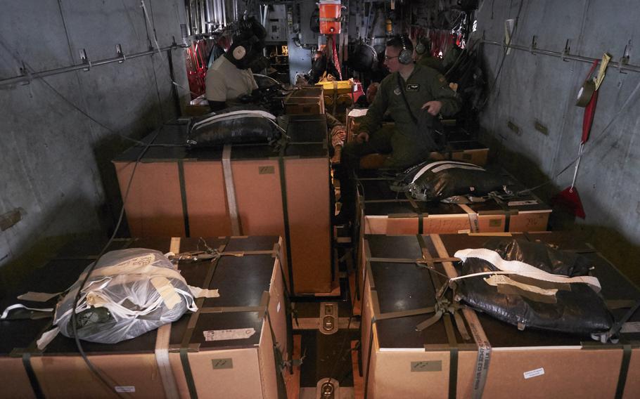 Loadmasters from Yokota Air Base's 374th Airlift Wing check bundles prior to airdropping them onto remote islands in Micronesia on Wednesday, Dec. 9, 2015.