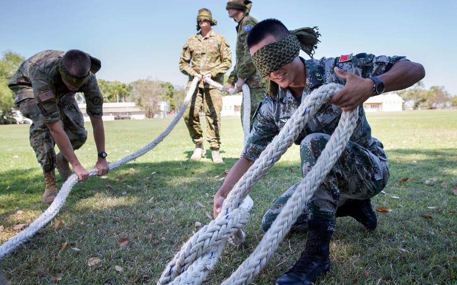 Chinese People's Liberation Army Cpl. Xing Wang unties a knot during team-building activities as part of Kowari 2016 at Larrakeyah Barracks in Darwin, Northern Territory. Kowari is an Australian army-hosted survival skills exercise designed to increase defense cooperation between forces from the U.S., Australia and China.