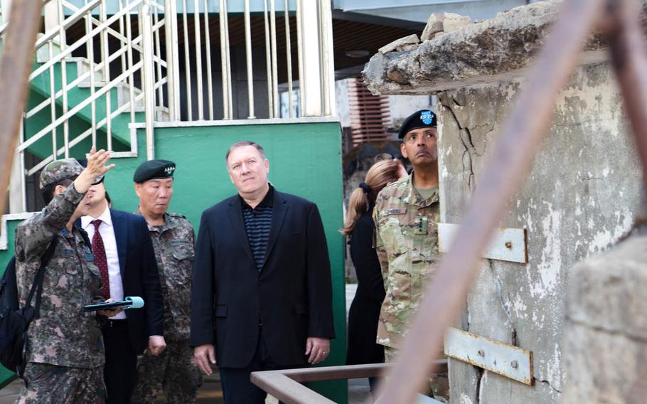 CIA Director Mike Pompeo, center, looks at damage from a 2010 North Korean artillery and rocket attack on Yeonpyeong Island, South Korea, Sunday, April 30, 2017.