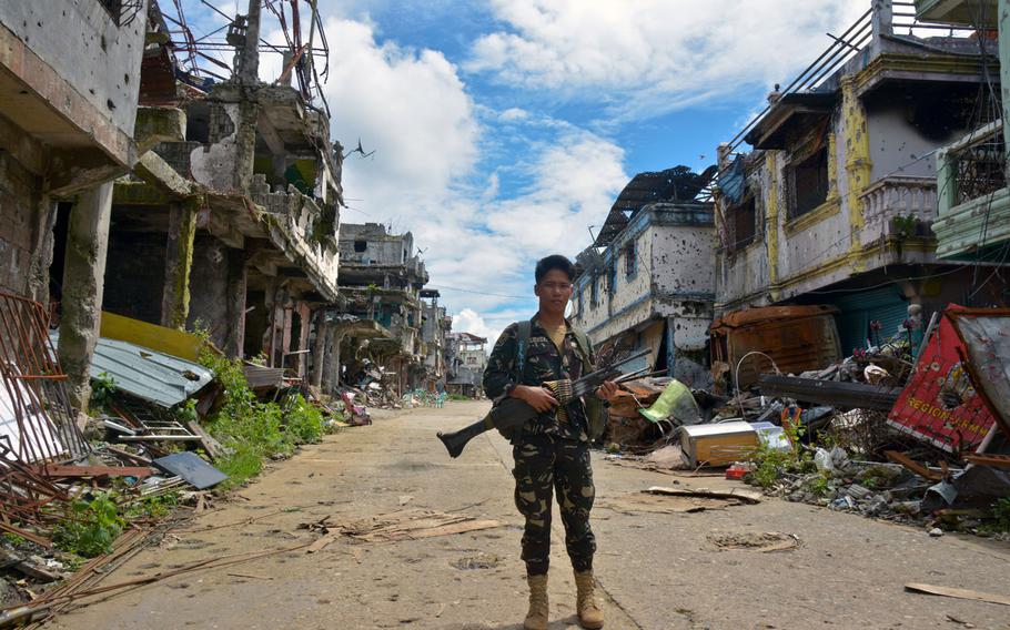 A Filipino soldier stands in the Marawi battle zone, Wednesday, Nov. 8, 2017.