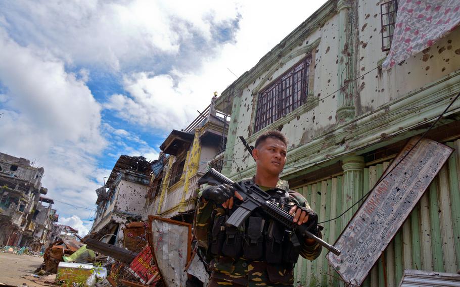 A Filipino soldier stands in the Marawi battle zone, Wednesday, Nov. 8, 2017.