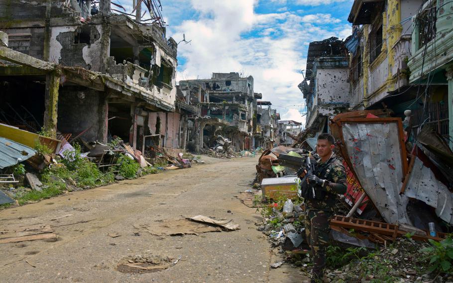 A Filipino soldier stands in the Marawi battle zone, Wednesday, Nov. 8, 2017.
