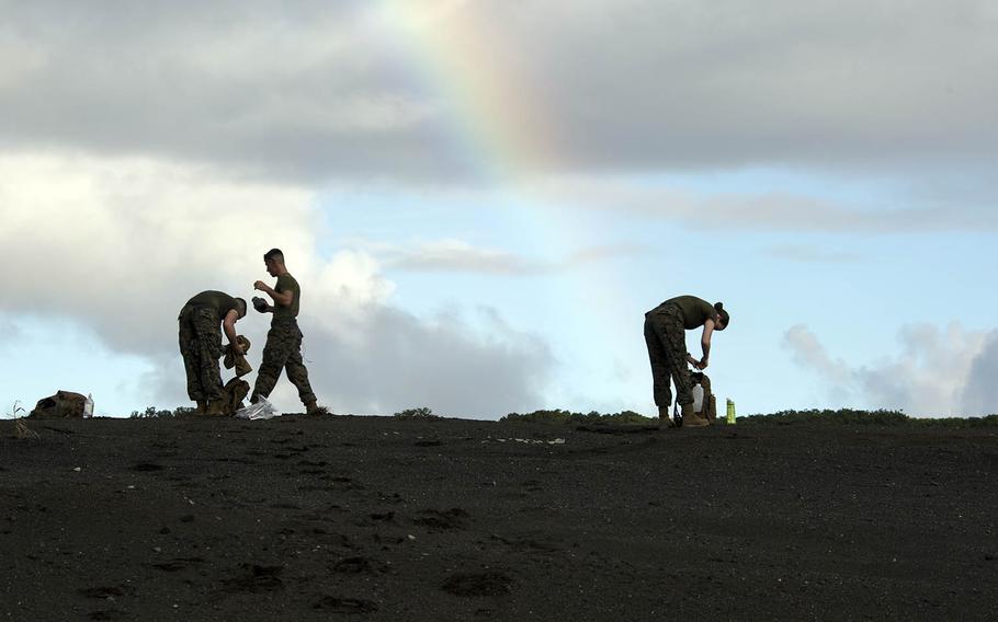 Marines from Marine Corps Air Station Iwakuni, Japan, collect sand on Iwo Jima, Nov. 7, 2017.