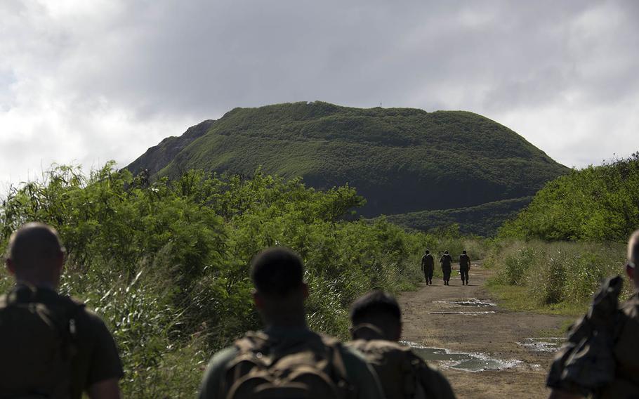 Servicemembers from Marine Corps Air Station Iwakuni, Japan, hike up Mount Suribachi on Iwo Jima, Nov. 7, 2017.