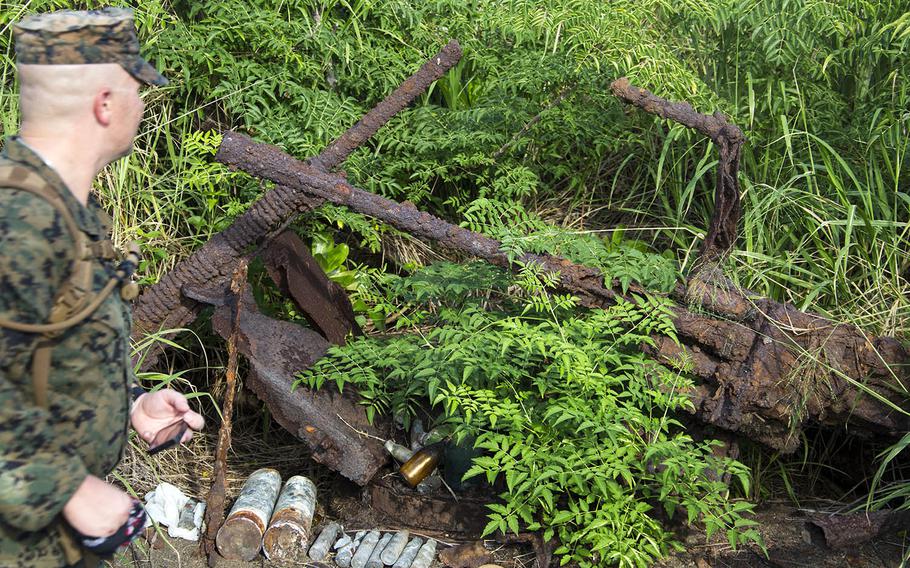 A Marine from Marine Corps Air Station Iwakuni, Japan, looks at an old machine-gun nest used in the Battle of Iwo Jima, Nov. 7, 2017.