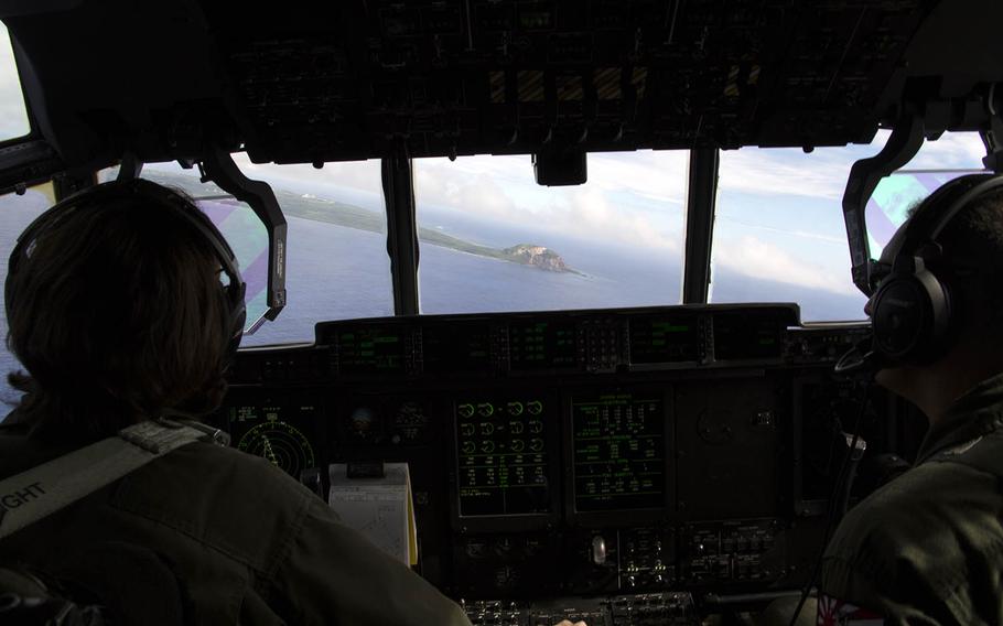 Marine Corps 1st Lt. Olivia Raftshol, a KC-130J Hercules co-pilot, left, and Maj. Matthew Stolzenberg, a KC-130J Hercules pilot, of Marine Aerial Refueler Transport Squadron 152, prepare to land at Iwo Jima, Japan, Nov. 7, 2017.