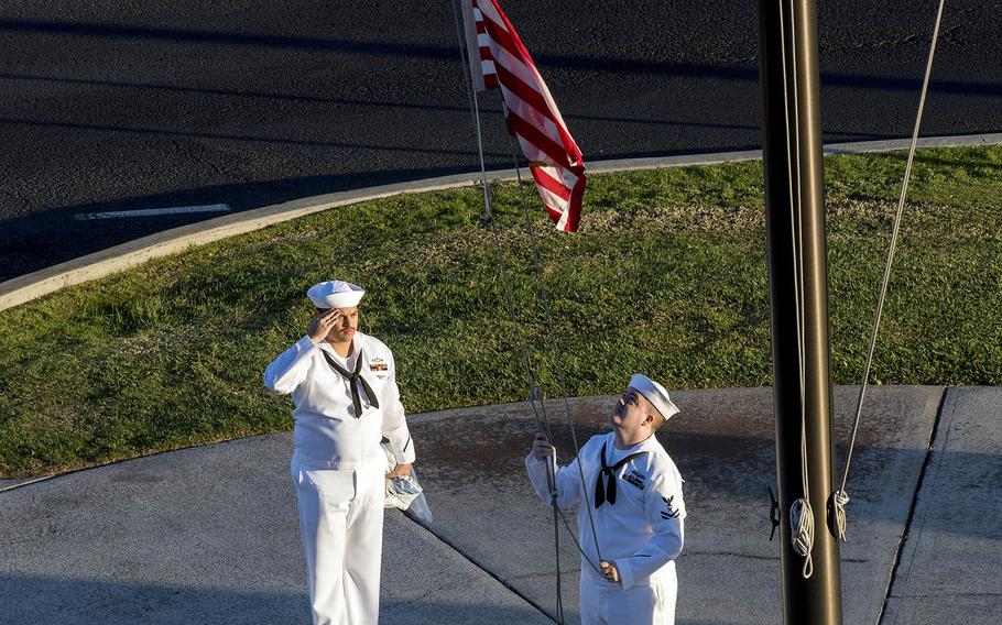 Petty Officer 2nd Class Gerado Taddei, left, and Petty Officer 2nd Class Andrew Thompson fly the First Navy Jack at Joint Base Pearl Harbor-Hickam, Hawaii, Monday, Jan. 1, 2018.