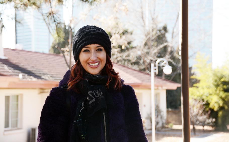 Samia Mounts stands in front of her old house at Yongsan Garrison, South Korea, Saturday, Feb. 17, 2018.