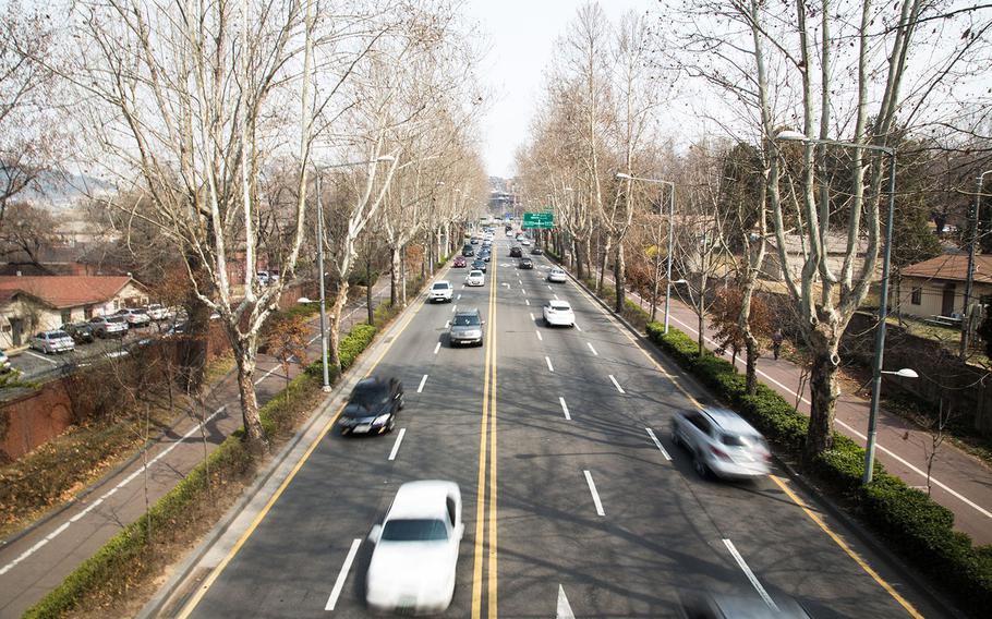 Cars zoom down a road bisecting Yongsan Garrison in Seoul, South Korea, Thursday, March, 30, 2017.