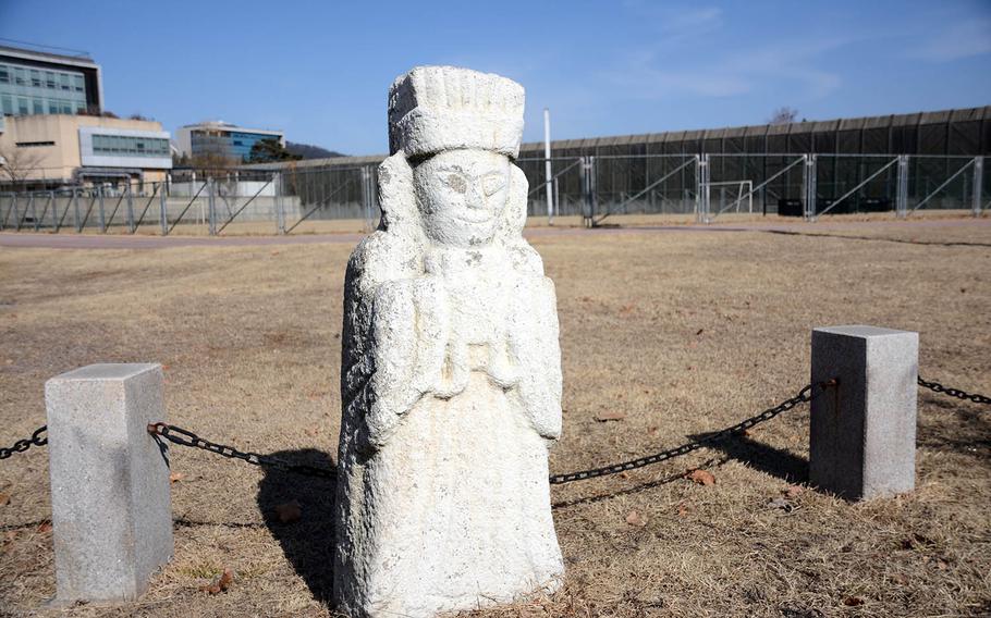 An ancient funerary statue near a running track at Yongsan Garrison, South Korea, serves as a reminder of the area's pre-military history.