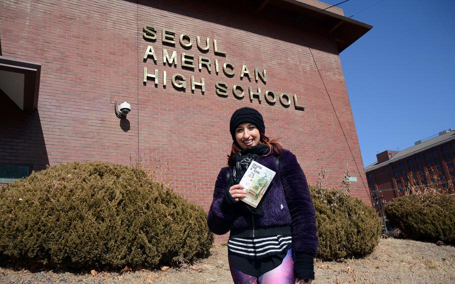 Samia Mounts stands in front of Seoul American High School at Yongsan Garrison, South Korea, Saturday, Feb. 17, 2018. Her book, "Frunk the Skunk," is a young adult novel set on the base.