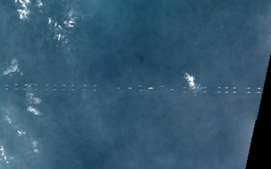 This satellite image taken Monday, March 26, 2018, shows a formation of Chinese ships off the coast of Hainan Province, China.