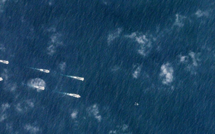 This satellite image taken Monday, March 26, 2018, shows Chinese ships off the coast of Hainan Province, China, during annual spring drills.