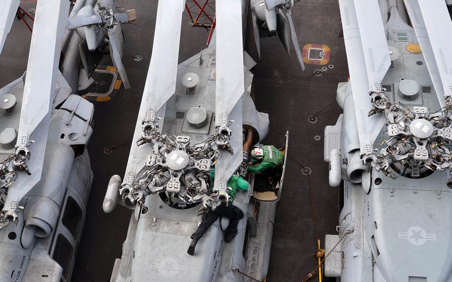 Sailors work on a Seahawk aboard the aircraft carrier USS Carl Vinson last month in the Philippine Sea.