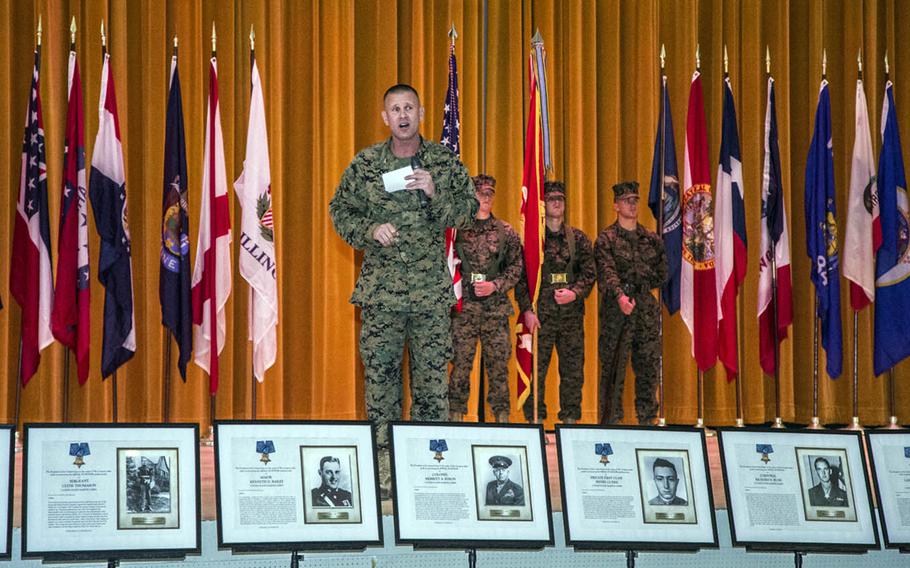 Marine Col. Kevin Norton, 4th Marine Regiment commander, speaks about the unit's history while standing behind photos of its numerous Medal of Honor recipients at Camp Schwab, Okinawa, March 9, 2017.