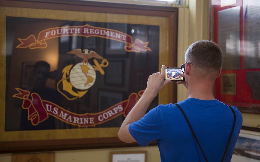 A Marine with the Okinawa-based 4th Marine Regiment takes a photo of the unit colors at the Pacific War Memorial Museum at Corregidor, Philippines, May 5, 2017.