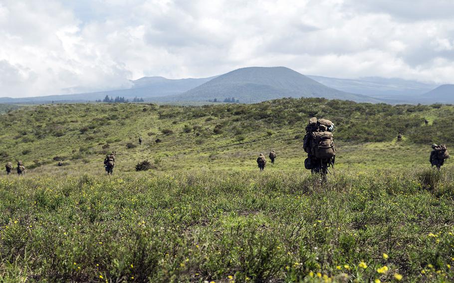 Marines with 2nd Battalion, 3rd Marine Regiment hike up a hill to dig fighting holes at the Pohakuloa Training Area on Hawaii Island, Oct. 31, 2017.