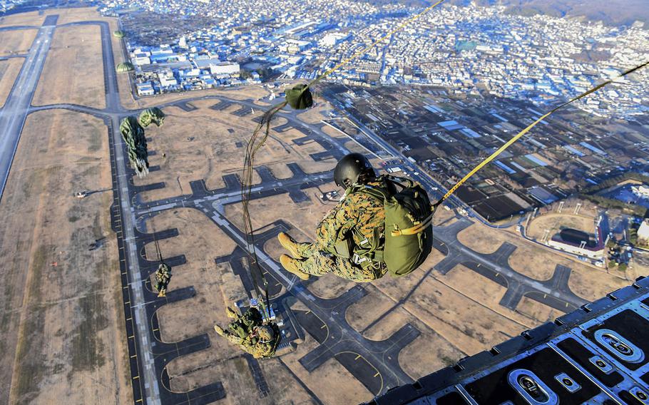 Marines with the 3rd Reconnaissance Battalion, 3rd Marine Division, III Marine Expeditionary Force, perform a static line parachute jump last year at Yokota Air Base, Japan.