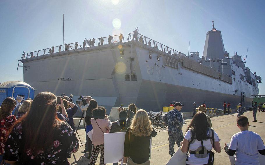 Local media and families gather on the pier as the San Antonio-class amphibious transport dock ship USS Portland arrives into its new homeport in San Diego, Jan. 22, 2018.