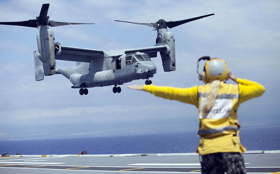 An Australian sailor guides a U.S. MV-22B Osprey as it takes off from HMAS Canberra in the Pacific Ocean, July 13, 2016.