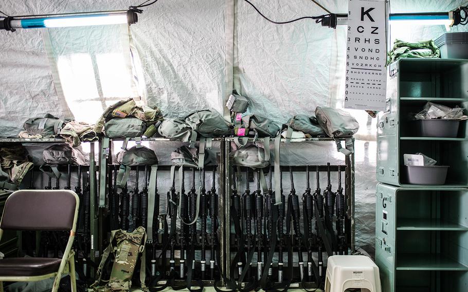 Eye charts, rifles and gas masks line the entrance to the 121st Combat Support Hospital at Camp Humphreys, South Korea, Friday, April 20, 2018.