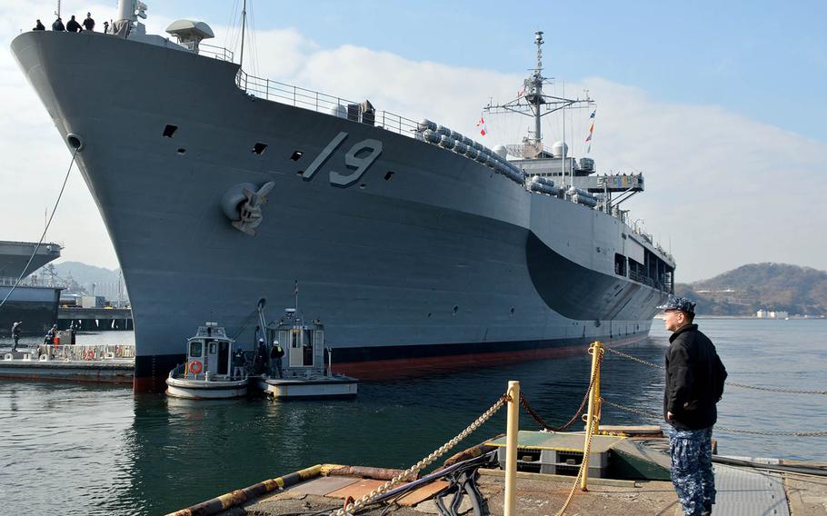 Capt. Jeffrey Kim, commander of Yokosuka Naval Base, Japan, stands near the USS Blue Ridge earlier this year.