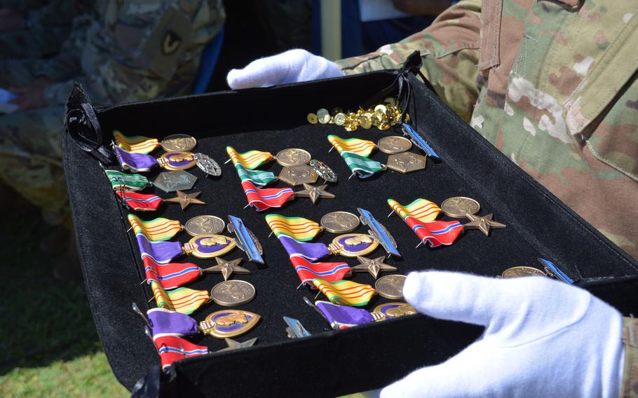 A soldier holds a tray of medals and awards during a ceremony at Fort Shafter, Hawaii, June 29, 2018.  The medals were presented to Vietnam War veterans from the 196th Infantry Brigade for service in the late 1960s and early 1970s, 