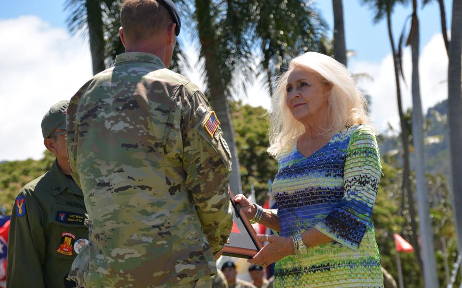 During a ceremony at Fort Shafter, Hawaii, June 29, 2018, Sherry Jones accepts a plaque from Col. Robert S. Berg, commander of the 196th Infantry Brigade, on behalf of her brother, Danny Widner, who went missing in action on May 12, 1968, during the Battle of Kham Duc, Vietnam. His remains have never been located.