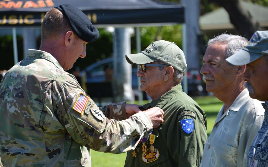 Col. Robert S. Berg, commander of the 196th Infantry Brigade, presents Orland V. Agosto with a Silver Star, Bronze Star, Purple Heart, Combat Infantry Badge and Vietnam Service Medal during a ceremony at Fort Shafter, Hawaii, June 29, 2018.