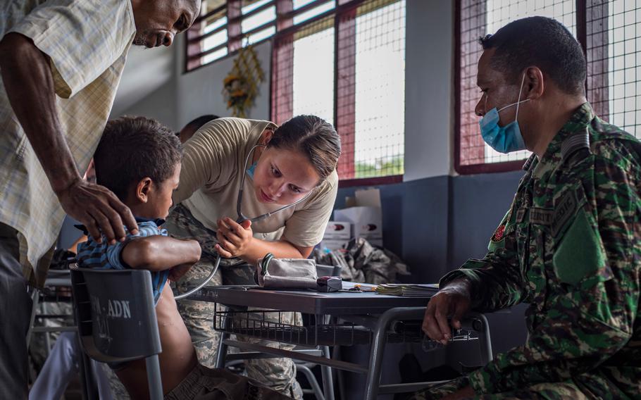 U.S. Air Force Senior Airman Hannah Zink, right, a 15th Aerospace Medicine Squadron aerospace medical technician from Joint Base Pearl Harbor-Hickam, Hawaii, checks his vitals at the Negri Saran Kote Secondary School during Pacific Angel 2018 in Suai, Cova Lima Municipality, Southwest Timor-Leste, June 11, 2018.