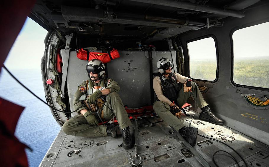 Members of Helicopter Sea Combat Squadron 25 wait inside an MH-60S Sea Hawk helicopter prior to a search-and-rescue exercise off the coast of Guam, Feb. 23, 2018.