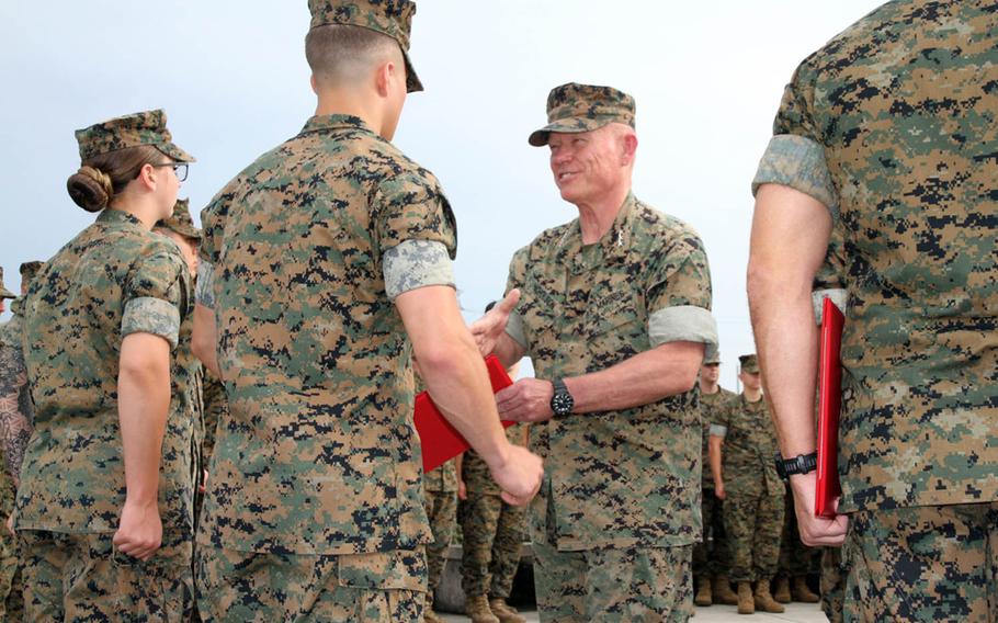 Lt. Gen. Lawrence Nicholson, III Marine Expeditionary Force commander, meritoriously promotes five Marines and a Navy corpsman at Camp Courtney, Okinawa, Thursday, Aug. 2, 2018.