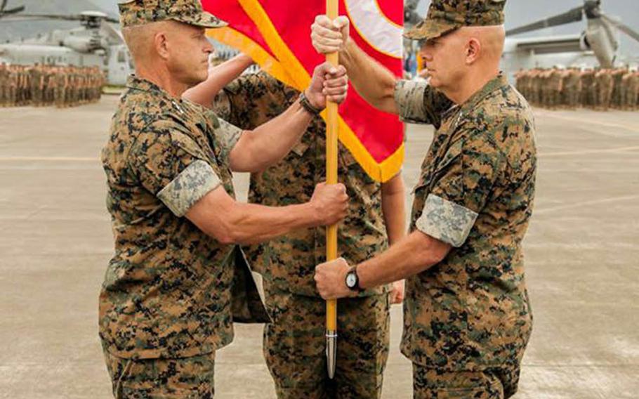 Lt. Gen. David Berger, right, outgoing commander of Marine Corps Forces Pacific, passes the colors to incoming commander Lt. Gen. Lewis Craparotta at Marine Corps Base Hawaii, Wednesday, Aug. 8, 2018.