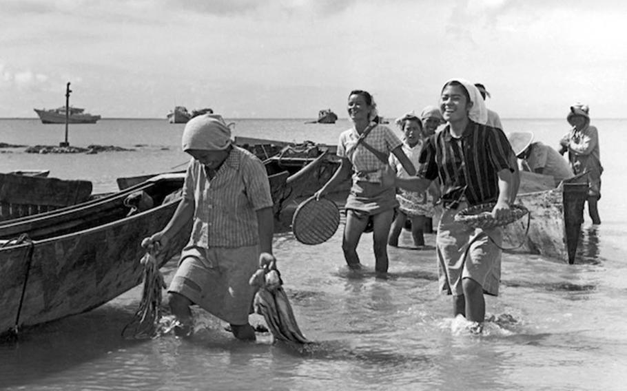 Okinawan women walk back to shore in this photo taken by Army Capt. Charles Gail, who was stationed on the Japanese island prefecture in 1952 and 1953.