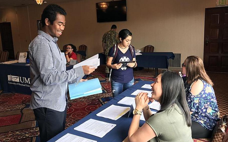 Servicemembers looking at post-military career options attend a job fair at Yokosuka Naval Base, Japan, Wednesday, Aug. 29, 2018.