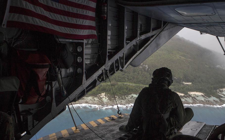 A CH-53E Super Stallion crew member watches over Rota in the Northern Marianas during typhoon relief efforts, Tuesday, Sept. 11, 2018.