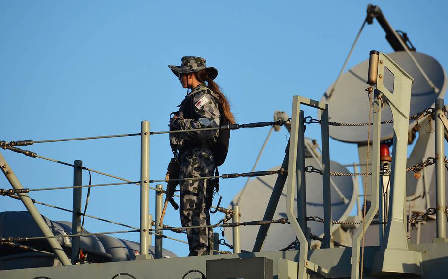 An Australian sailor stands high above the deck of the HMAS Hobart, where Americans and Australians gathered to celebrate a century of "mateship," Sept. 18, 2018.