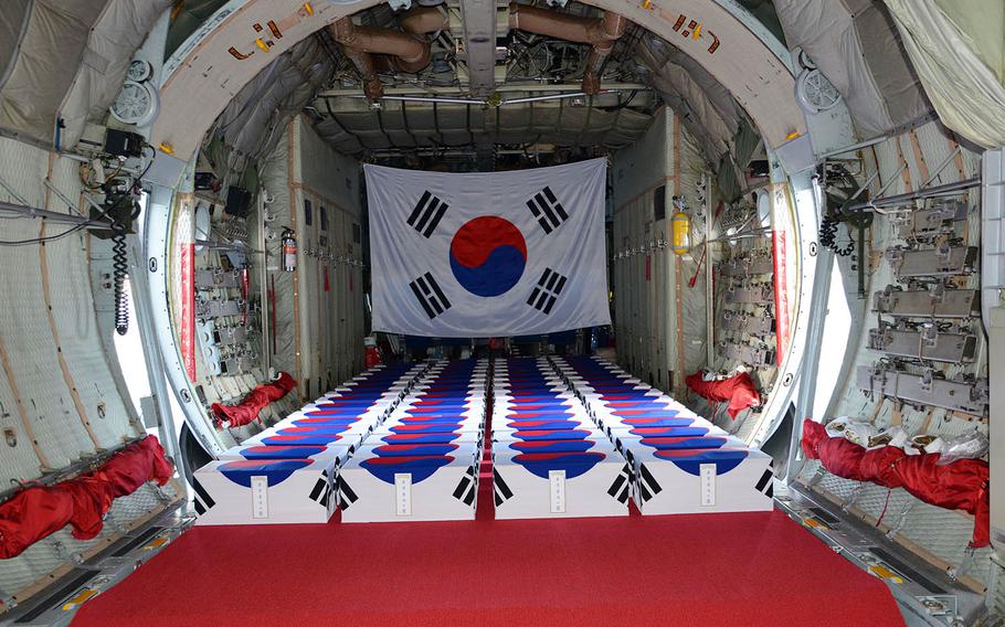 Draped in South Korean flags, 63 boxes of remains fill the hold of a C-130 cargo plane ahead of a repatriation ceremony at Joint Base Pearl Harbor-Hickam, Hawaii, Thursday, Sept. 27, 2018.
