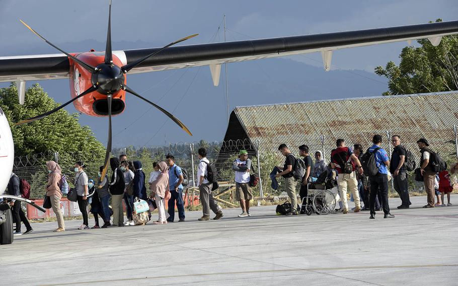 Evacuees prepare to board aircraft in Palu, Indonesia, Oct. 6, 2018. Thousands were displaced after a 7.5-magnitude earthquake and tsunami struck on Sept. 28, 2018.