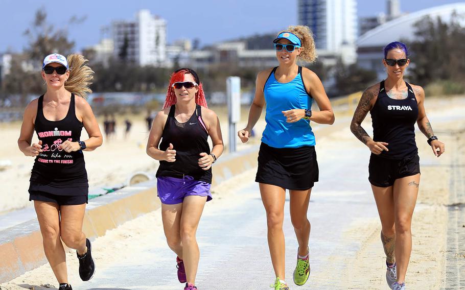 Marine Corps spouse Alyx Ulbrich, far right, trains with friends for the upcoming Decaman USA race Nov. 6, 2018, in New Orleans.