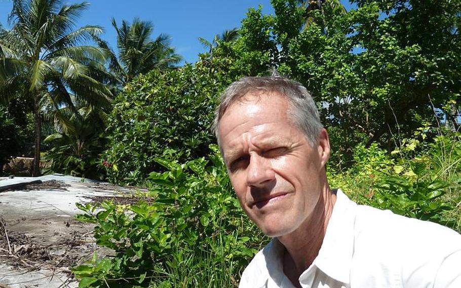 Author Clay Bonnyman Evans poses atop the Japanese blockhouse in the Tarawa atoll where his grandfather, Marine 1st Lt. Alexander Bonnyman Jr., fought and died in November 1943.