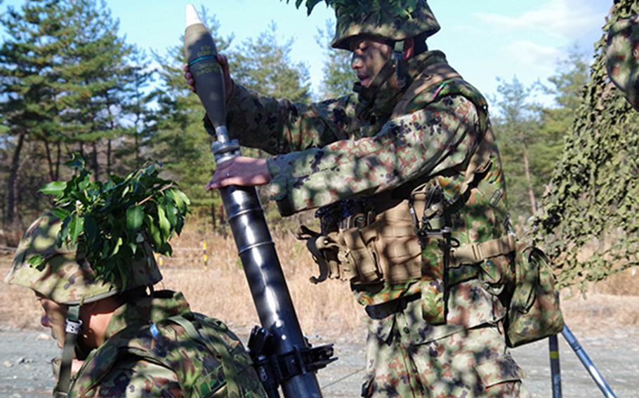 Japanese soldiers participate in mortar training at the Aibano Training Area in Takashima City, Shiga prefecture, in this undated photos provided by the Japan Ground Self-Defense Force.