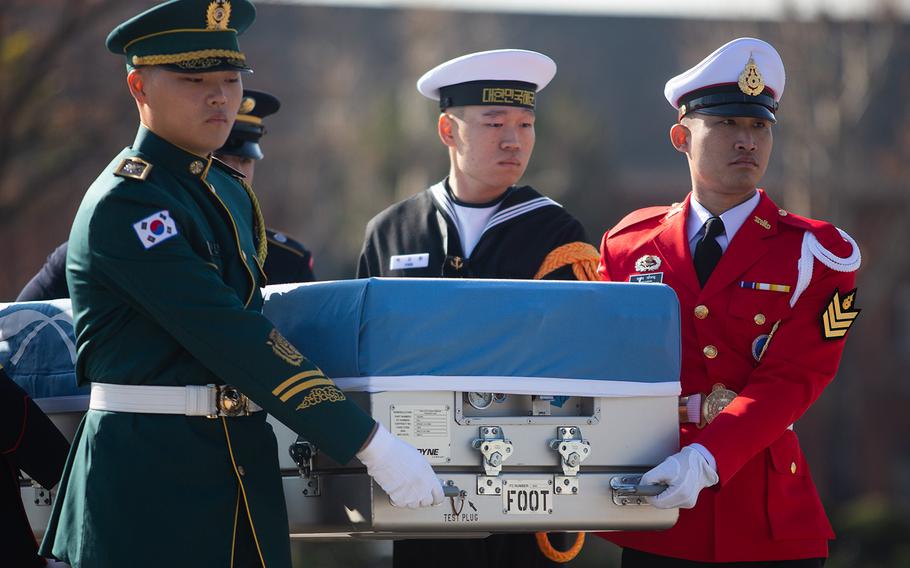 A United Nations Command honor guard carries Korean War remains at Yongsan Garrison in Seoul, South Korea, Tuesday, Nov. 20, 2018.