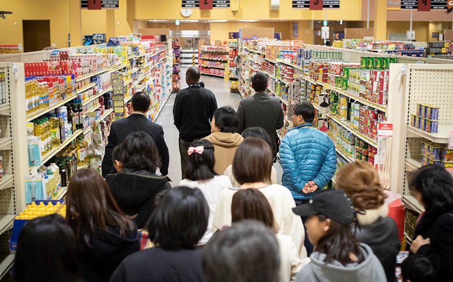 Japanese schoolchildren and their parents tour the commissary at Marine Corps Air Station Iwakuni, Japan, Monday, Jan. 14, 2019, during a community relations tour of the installation.