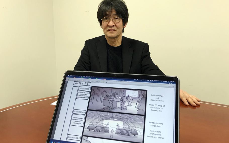 Japanese filmmaker Nobuyuki Kajikawa, shown here on Thursday, Jan. 17, 2019, shows illustrations of scenes from a movie slated to be filmed at Yokota Air Base, Japan, on Jan. 28. 