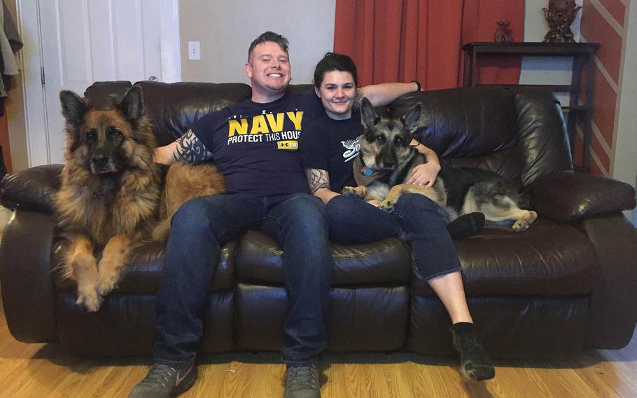 Kenneth and Emily Sanders pose with their dogs Phoenix, left, and Nautia in this undated photo. The Navy couple is facing an $11,592 bill to ship the dogs to Guam, where Kenneth will be assigned for three years.