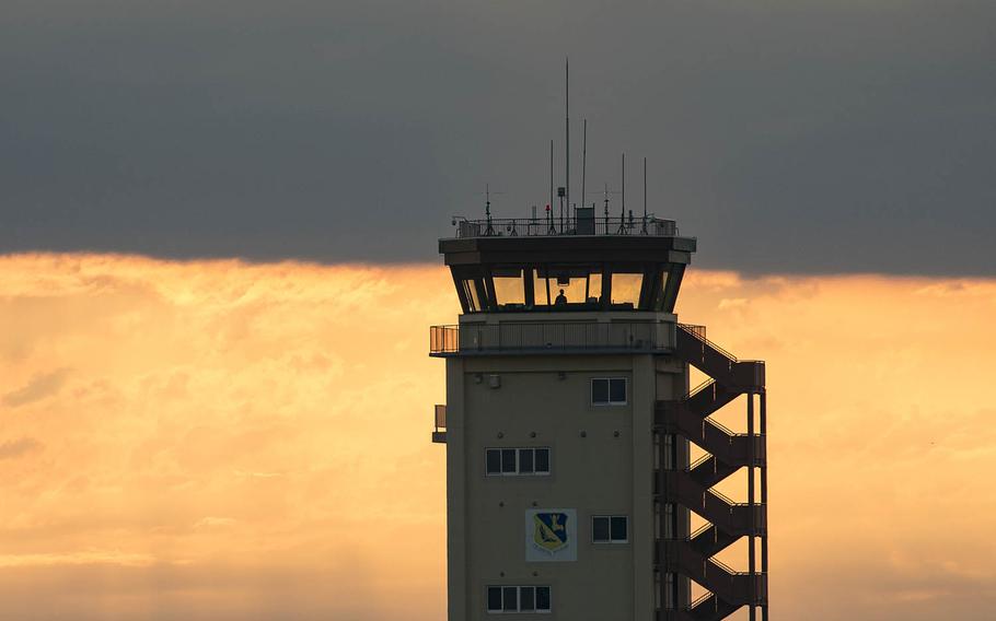 An air traffic controller with the 374th Operations Support Squadron looks out from the control tower at Yokota Air Base, Japan, June 4, 2017.